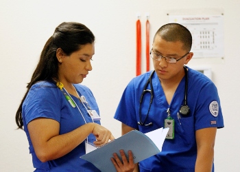 Two Nursing Students Looking at Chart