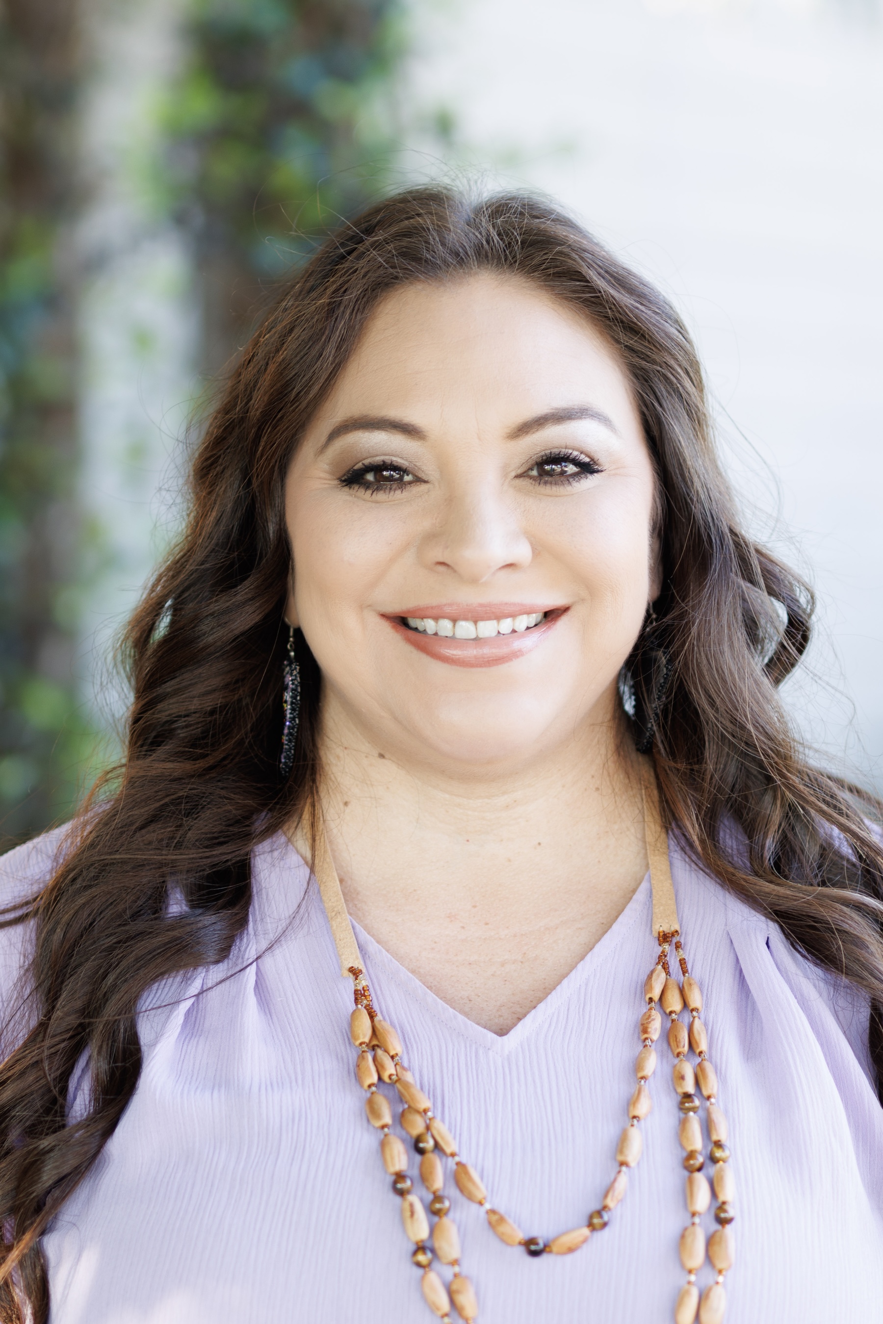 Smiling woman in a pink top.