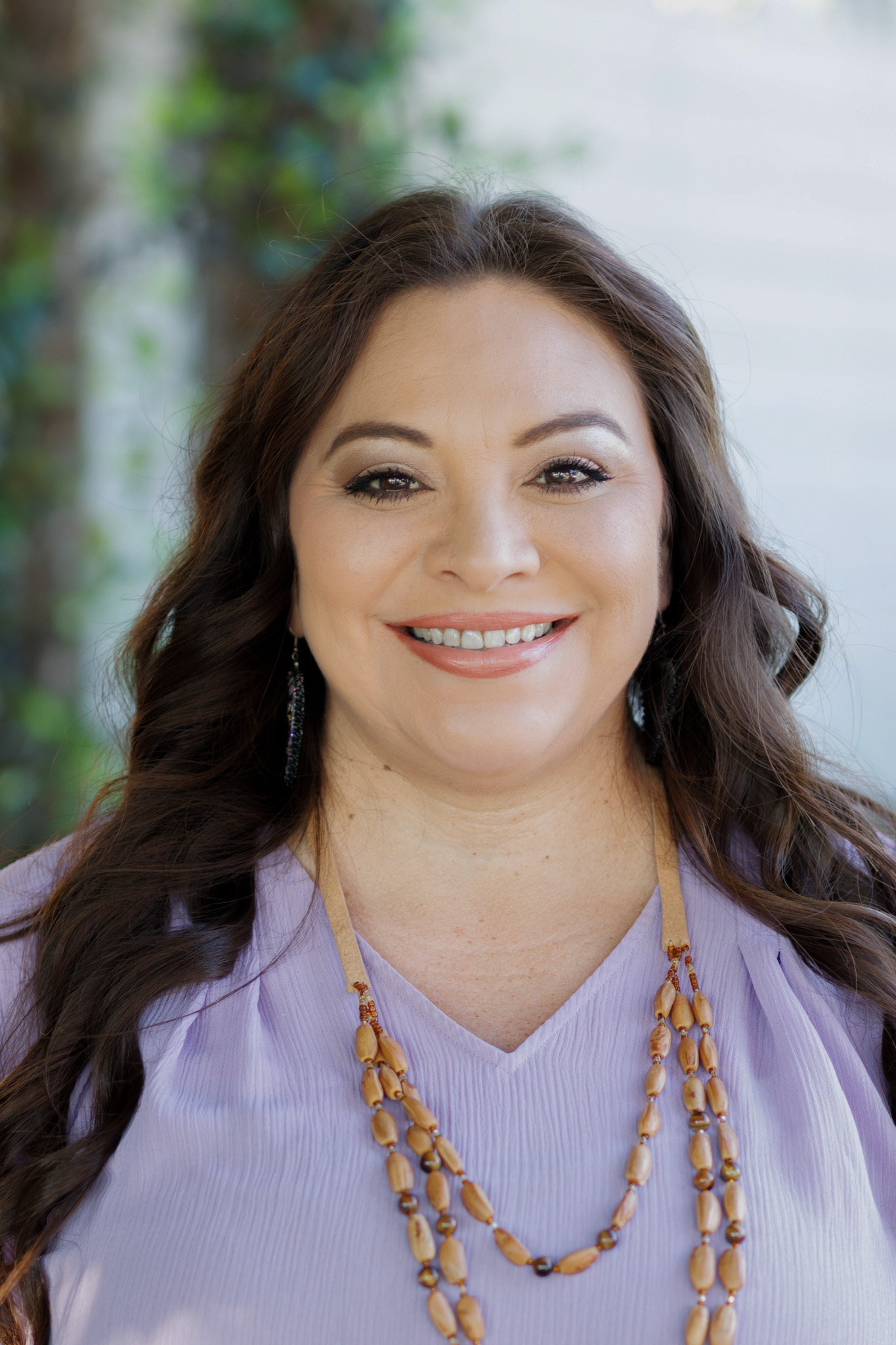 Smiling woman in a pink top.