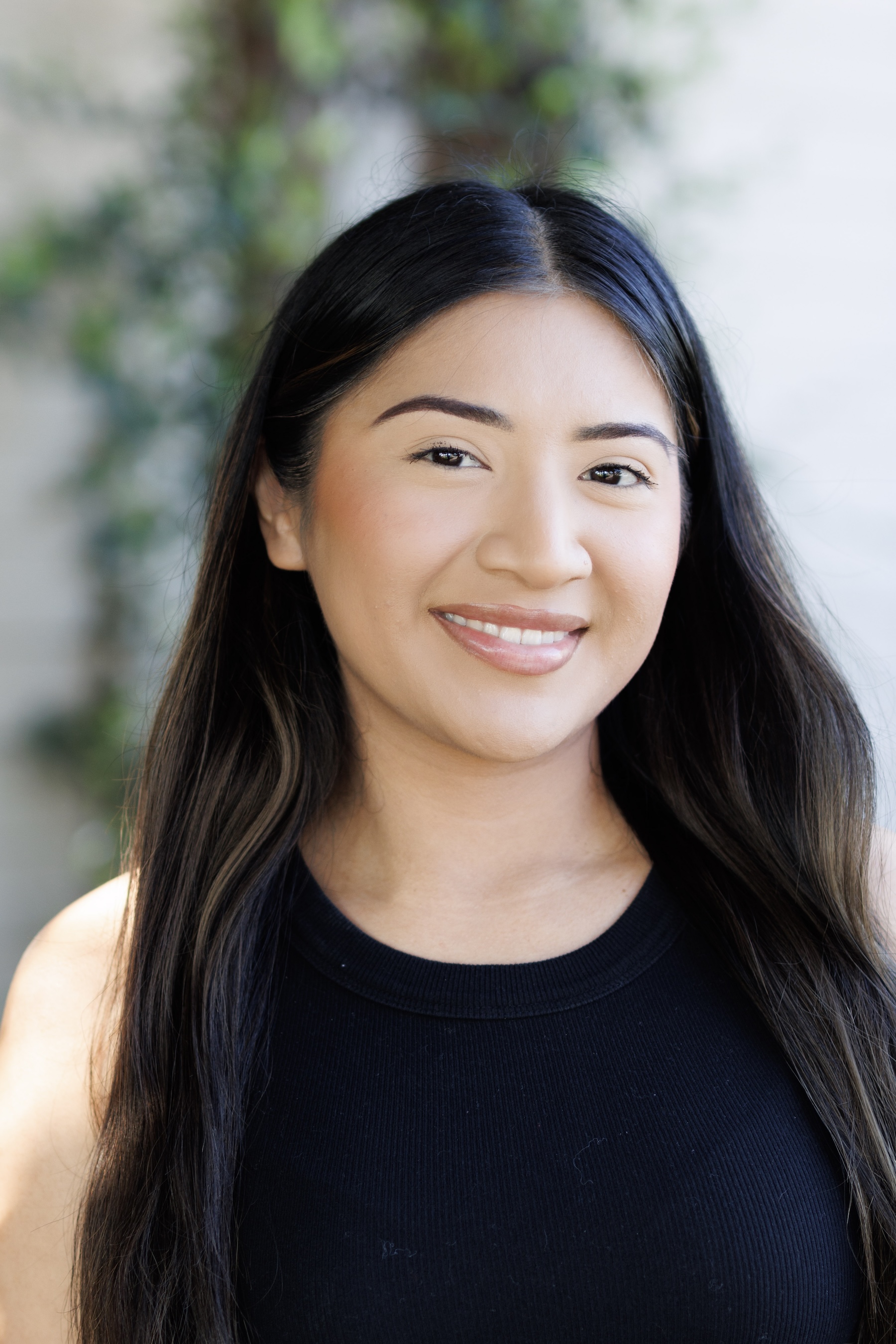 Smiling woman in a black top outdoors