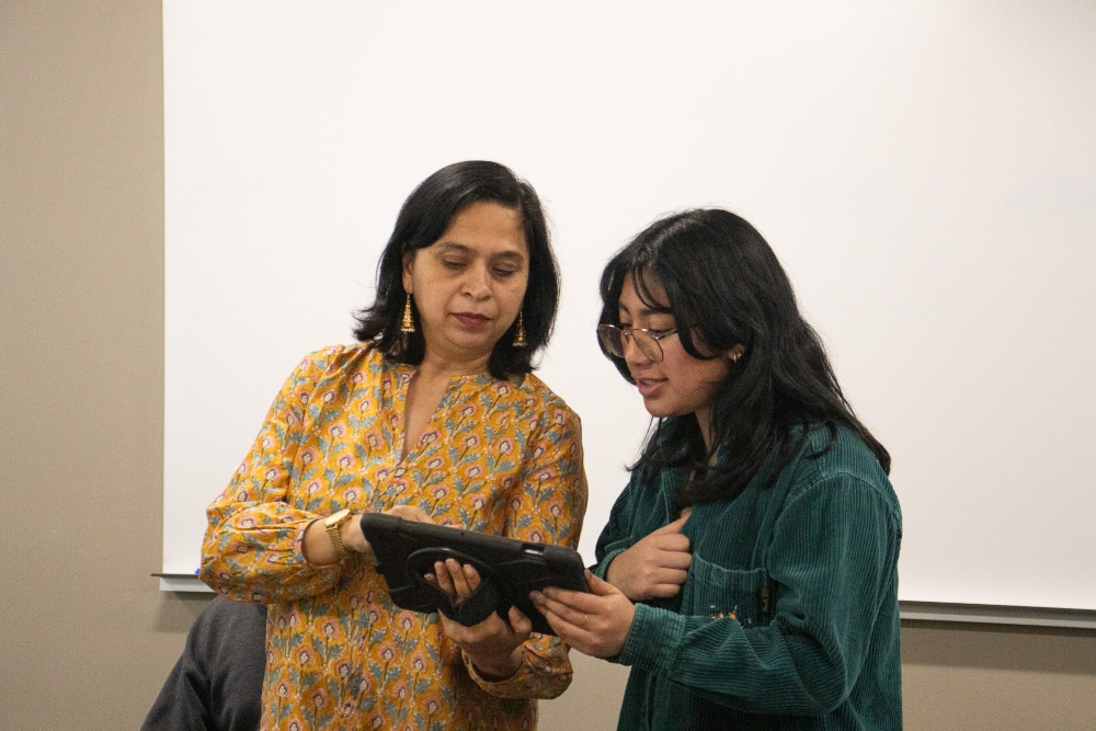Professor shows siudent an image on tablet 