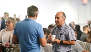 Two faculty members talking to each other