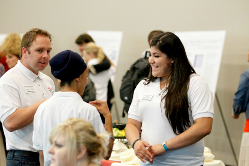 Student being given explanation during a fair.