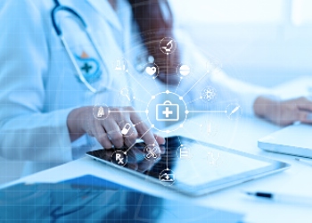 healthcare professional in a white coat uses a digital tablet with overlaid medical icons and data graphics
