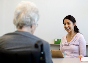 A Woman Smiling at an Elderly Woman