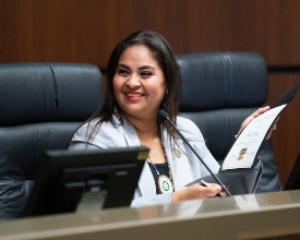 Maria Pacheco smiles at someone during City Hall meeting