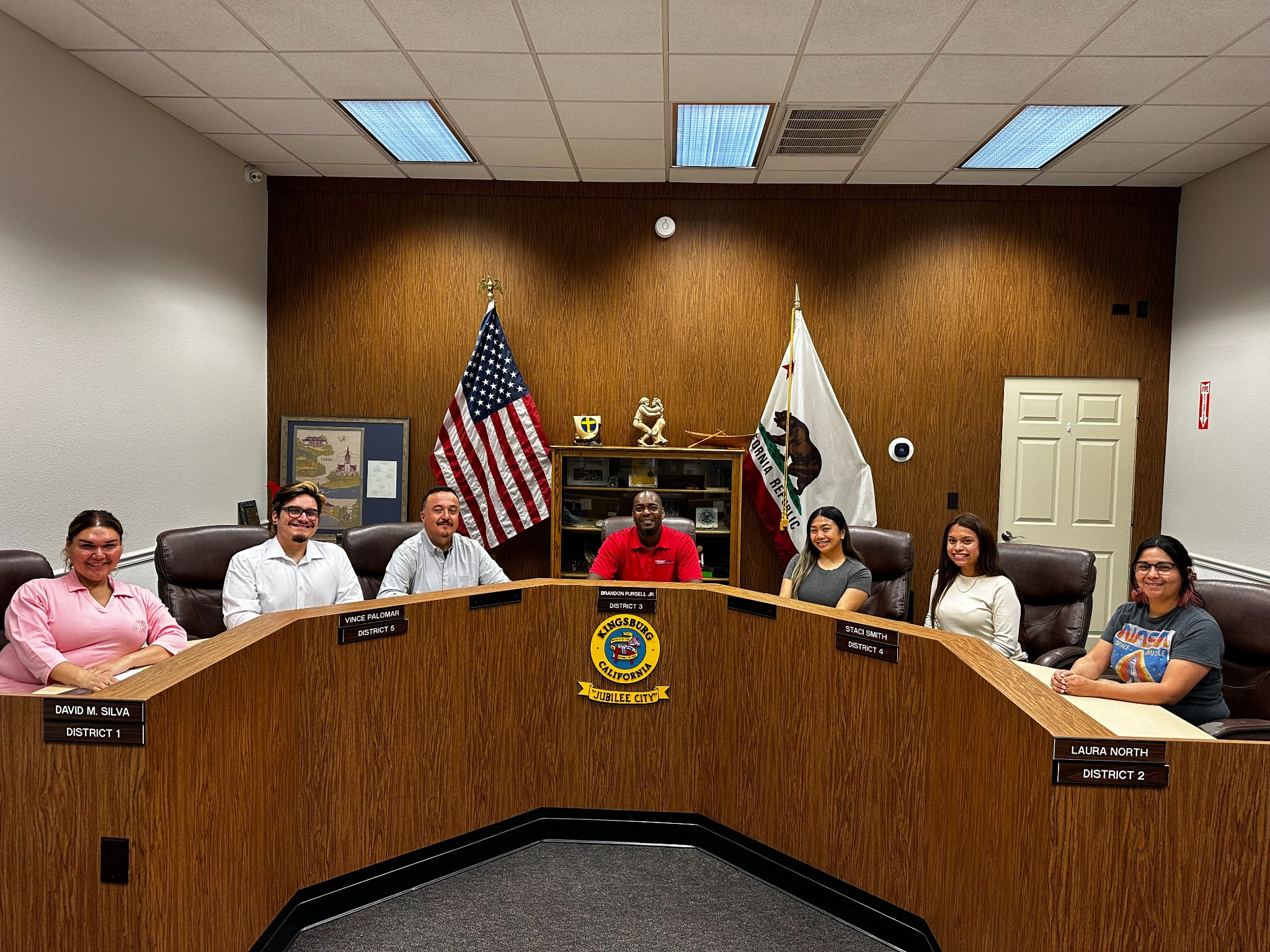 REC 77s students and Dr. Brandon Taylor sitting in Kingsburg city council seats for a photo op.
