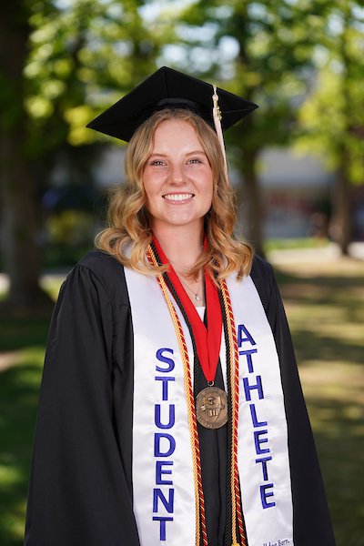 Katelyn Lehigh wearing student athlete stole, cap, and gown.